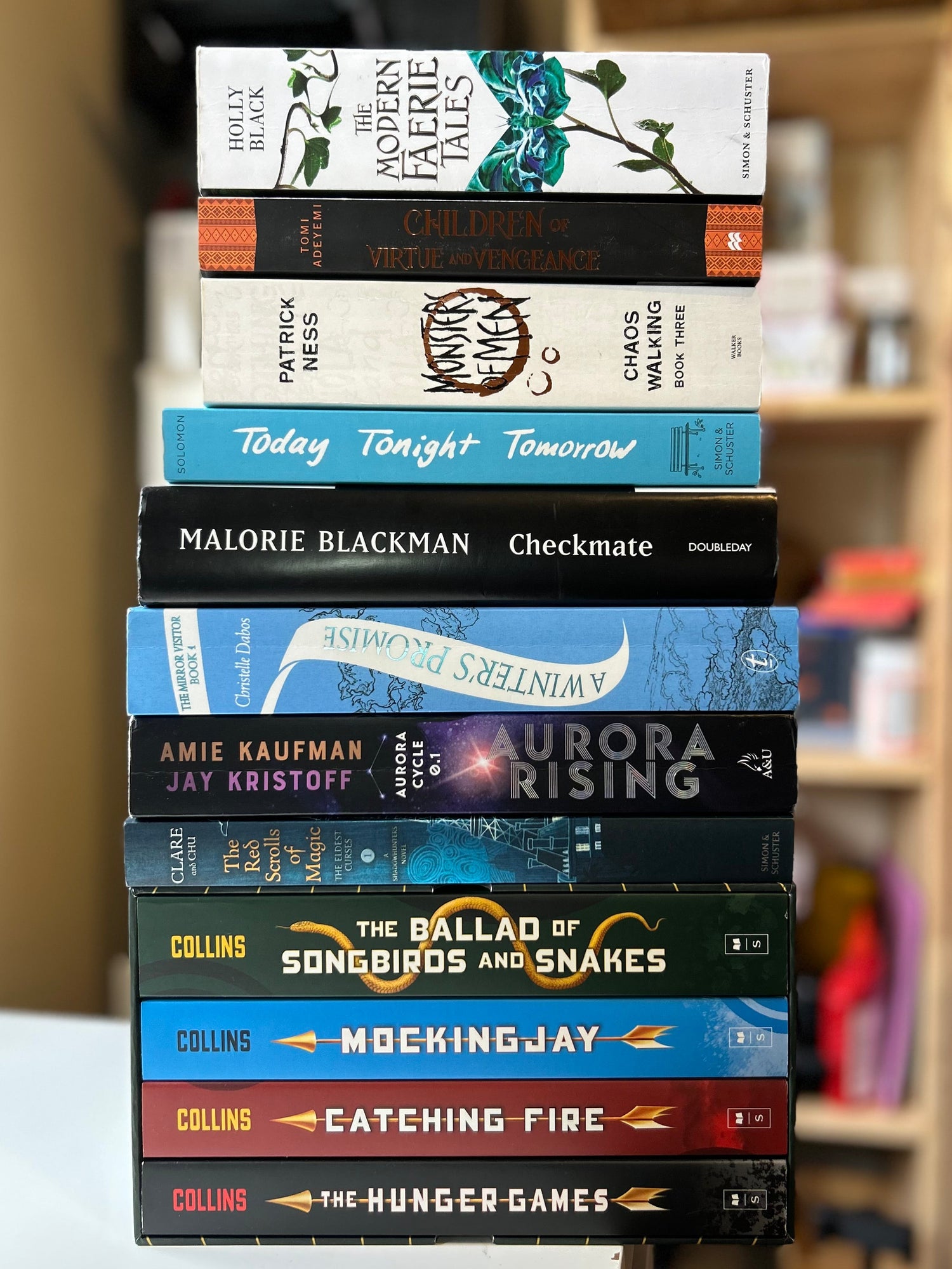 Stack of books with visible titles in a library setting